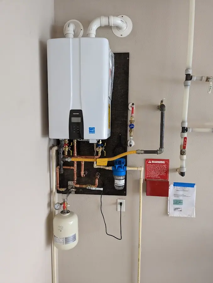 Professional plumber installing copper piping in a Palmdale home